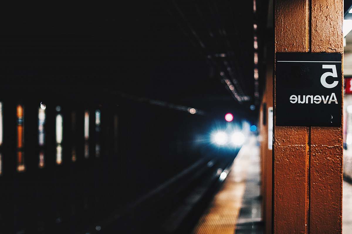 subway closeup photography of 5 Avenue train tunnel train